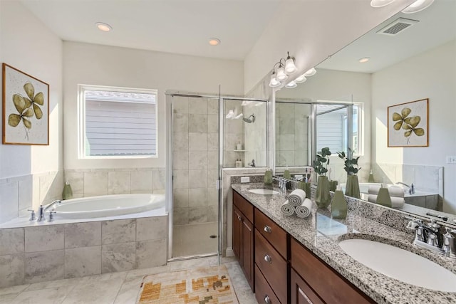 9945 Comely Bnd, Manor, TX 78653 - full bathroom with double vanity, a garden tub, a shower stall, and tile patterned floors