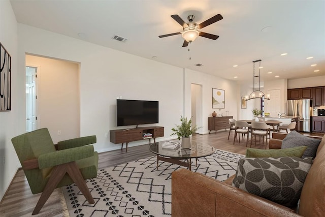 9945 Comely Bnd, Manor, TX 78653 - living area featuring light wood-style floors, a ceiling fan, and recessed lighting