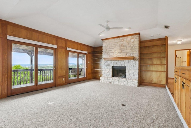 21009 Fawn Ridge Dr, Lago Vista, TX 78645 - unfurnished living room with built in shelves, vaulted ceiling, a ceiling fan, and carpet floors