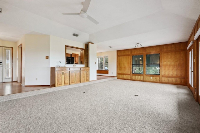 21009 Fawn Ridge Dr, Lago Vista, TX 78645 - unfurnished living room with visible vents, a ceiling fan, a sink, baseboards, and light colored carpet