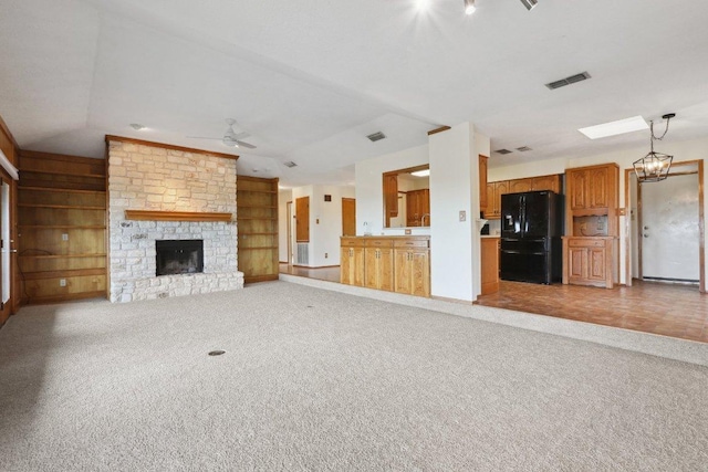 21009 Fawn Ridge Dr, Lago Vista, TX 78645 - unfurnished living room with vaulted ceiling, visible vents, a ceiling fan, a fireplace, and carpet flooring