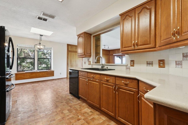 21009 Fawn Ridge Dr, Lago Vista, TX 78645 - kitchen with black appliances, brown cabinets, a sink, and plenty of natural light
