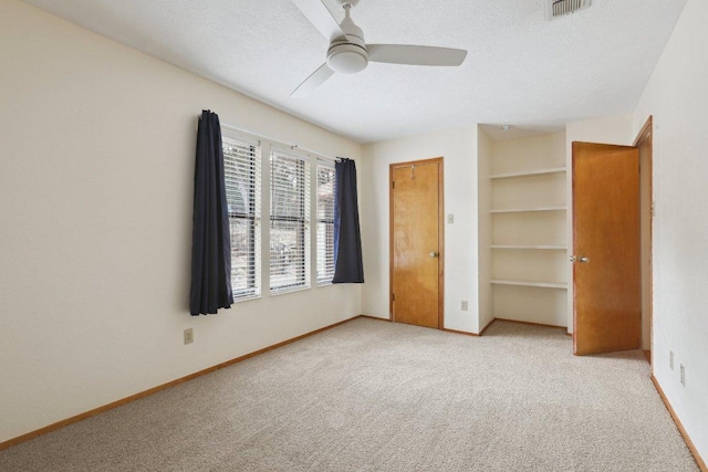 21009 Fawn Ridge Dr, Lago Vista, TX 78645 - unfurnished bedroom featuring baseboards, a textured ceiling, visible vents, and carpet