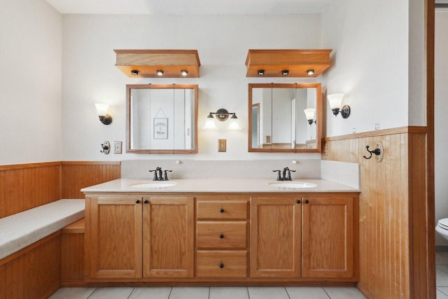 21009 Fawn Ridge Dr, Lago Vista, TX 78645 - bathroom featuring a wainscoted wall, wood walls, and a sink