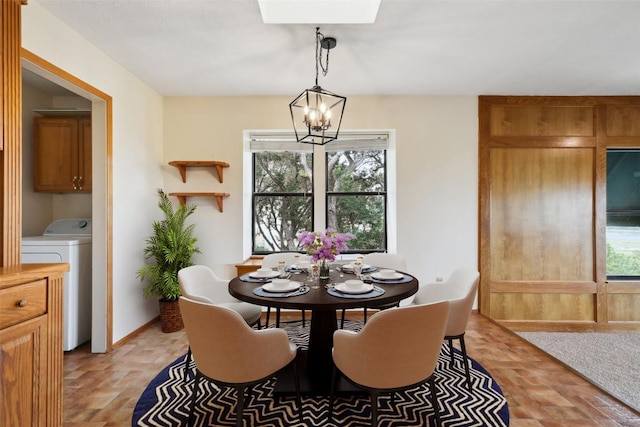 21009 Fawn Ridge Dr, Lago Vista, TX 78645 - dining room with washer / dryer, a chandelier, and brick floor
