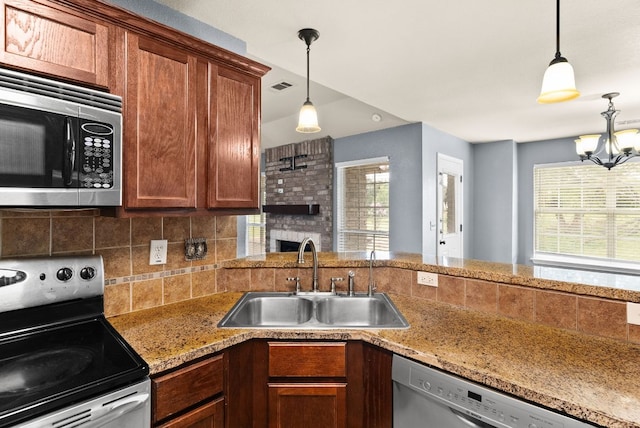 6060 County Road 3300, Kempner, TX 76539 - kitchen with tasteful backsplash, a sink, stainless steel appliances, decorative light fixtures, and visible vents