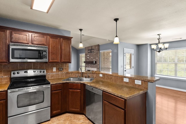 6060 County Road 3300, Kempner, TX 76539 - kitchen featuring decorative backsplash, stainless steel appliances, a peninsula, and a sink