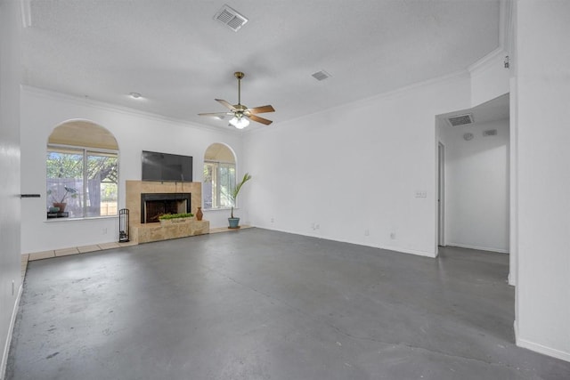 unfurnished living room featuring finished concrete floors, ornamental molding, a fireplace, a ceiling fan, and baseboards