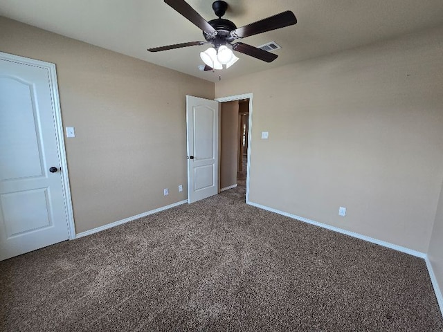 unfurnished bedroom featuring visible vents, carpet flooring, baseboards, and ceiling fan