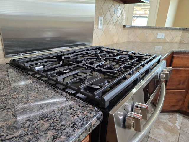 4125 Autumnwood Trl, San Angelo, TX 76904 - kitchen view of gas stove, backsplash, brown cabinetry, and stone counters