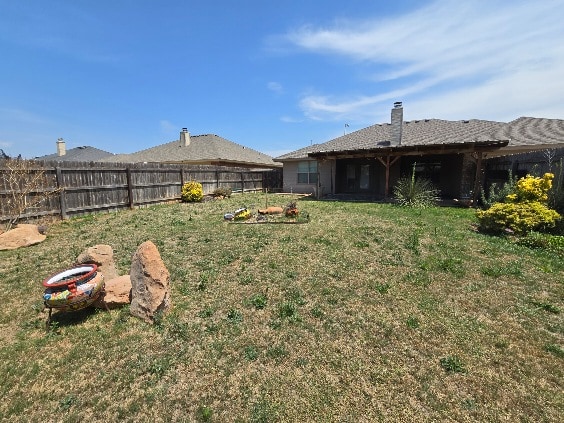view of yard with a fenced backyard