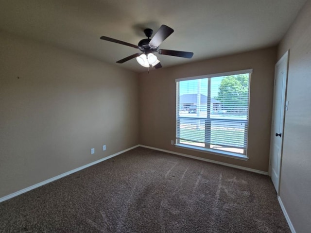 empty room featuring baseboards, carpet floors, and ceiling fan