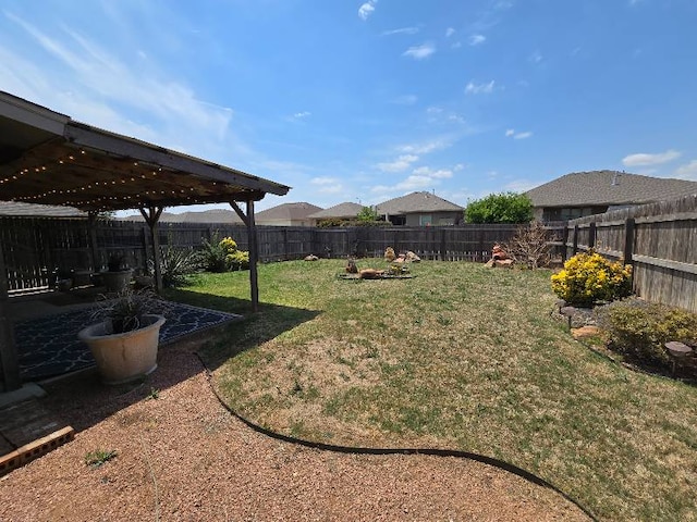 view of yard with a pergola, a fenced backyard, and a patio