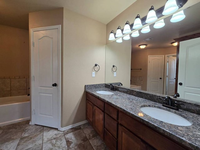 4125 Autumnwood Trl, San Angelo, TX 76904 - bathroom featuring double vanity, a bath, and baseboards