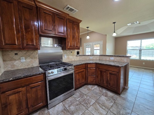 kitchen featuring tasteful backsplash, gas stove, and visible vents