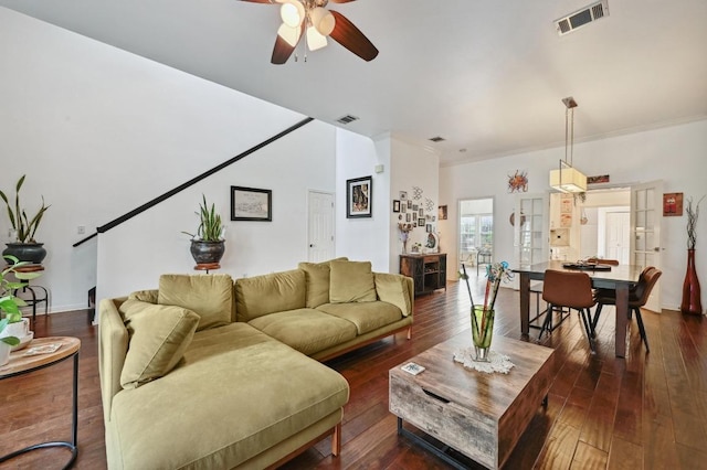 living area with ceiling fan, crown molding, dark wood-type flooring, and visible vents