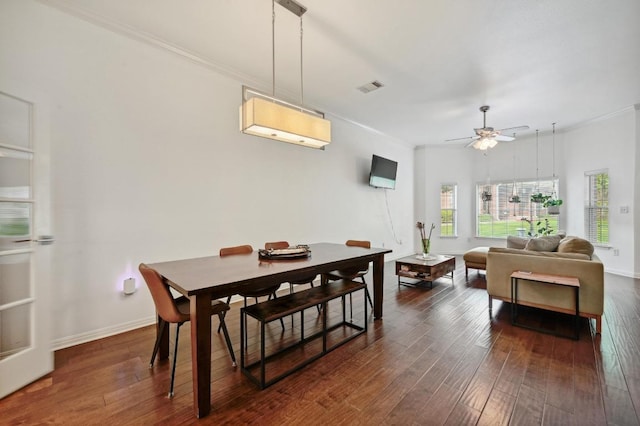 dining room with baseboards, crown molding, and dark wood-style floors