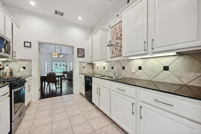kitchen with white cabinets, stainless steel appliances, a sink, visible vents, and light tile patterned floors