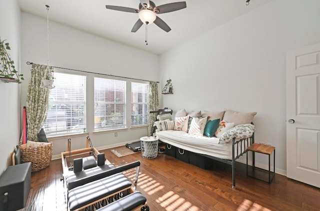 living room featuring wood finished floors, baseboards, and ceiling fan