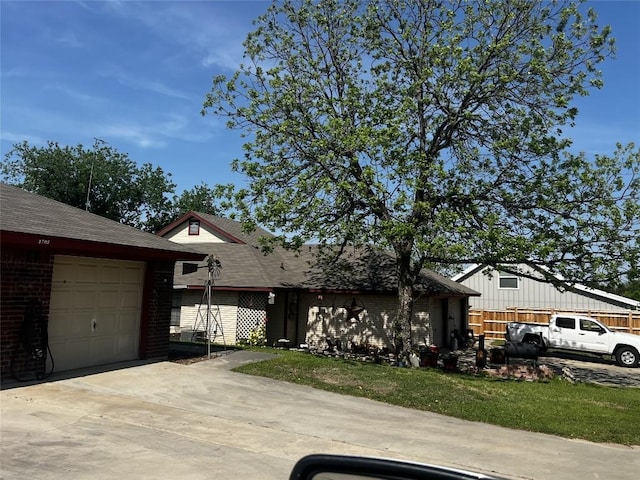 view of front of home featuring concrete driveway, brick siding, roof with shingles, and a garage