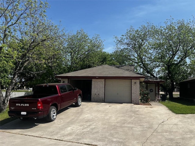 exterior space with brick siding and a detached garage
