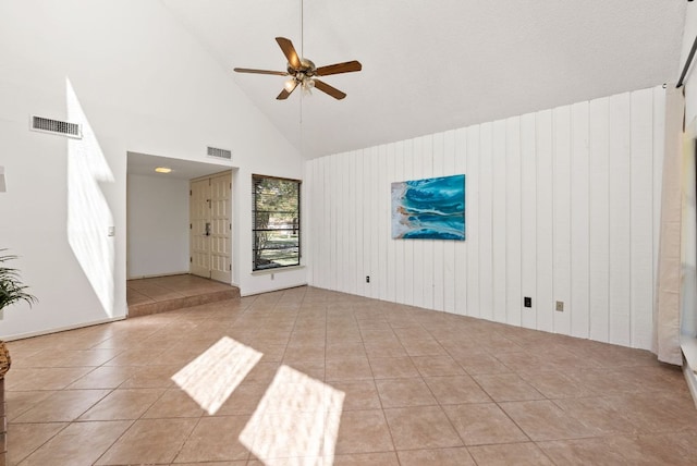 unfurnished living room featuring ceiling fan, high vaulted ceiling, and tile patterned flooring