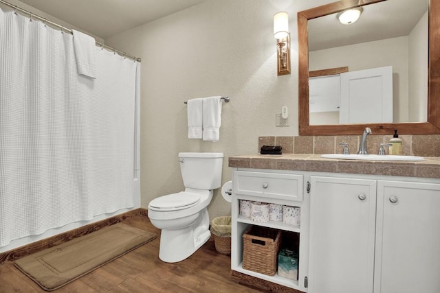 full bath featuring shower / bath combo, toilet, vanity, and wood finished floors