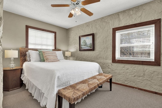 bedroom featuring carpet flooring, ceiling fan, and multiple windows
