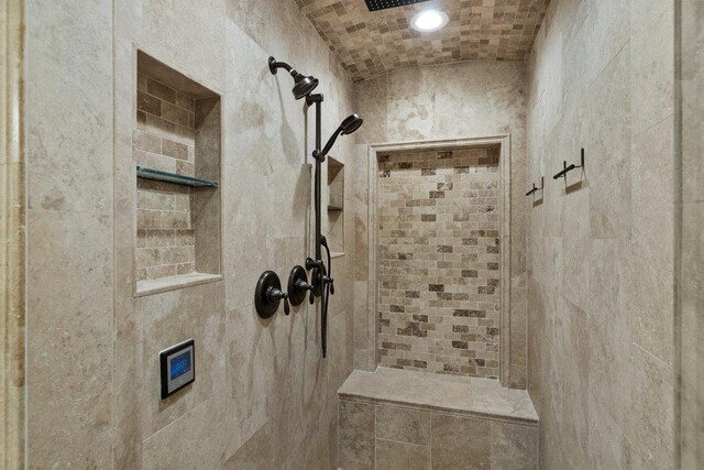 bathroom with a tile shower