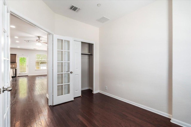 608 Lookout Tree Ln, Round Rock, TX 78664 - unfurnished bedroom featuring dark wood finished floors, baseboards, and visible vents