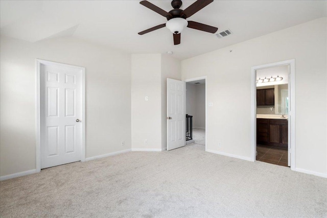 608 Lookout Tree Ln, Round Rock, TX 78664 - unfurnished bedroom with ceiling fan, baseboards, ensuite bath, carpet flooring, and visible vents
