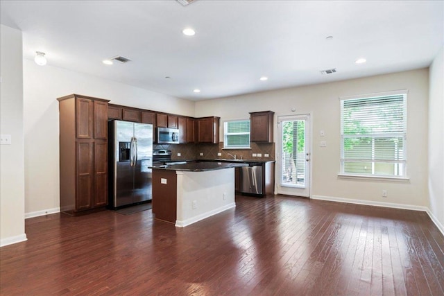608 Lookout Tree Ln, Round Rock, TX 78664 - kitchen with dark wood-style floors, stainless steel appliances, visible vents, and a kitchen island
