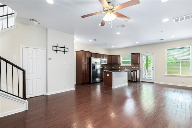 608 Lookout Tree Ln, Round Rock, TX 78664 - kitchen with open floor plan, stainless steel appliances, baseboards, visible vents, and a kitchen island
