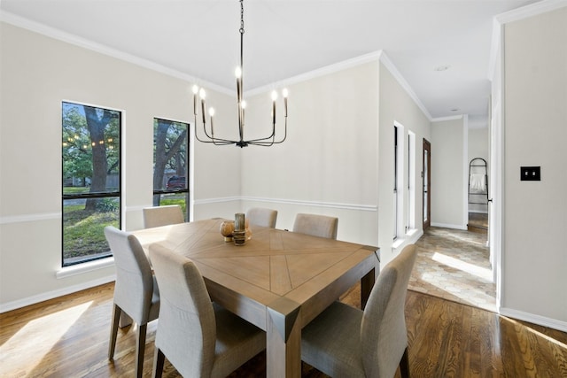 3614 Serena Woods Ct, Austin, TX 78759 - dining room with wood finished floors, crown molding, baseboards, and an inviting chandelier