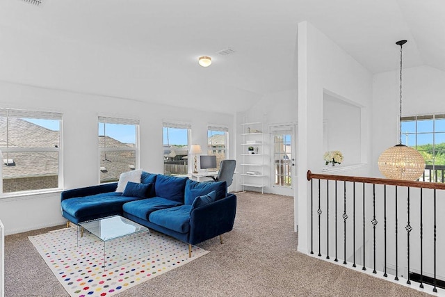 12207 Coronilla Bnd, Austin, TX 78748 - carpeted living area with plenty of natural light, vaulted ceiling, visible vents, and a notable chandelier
