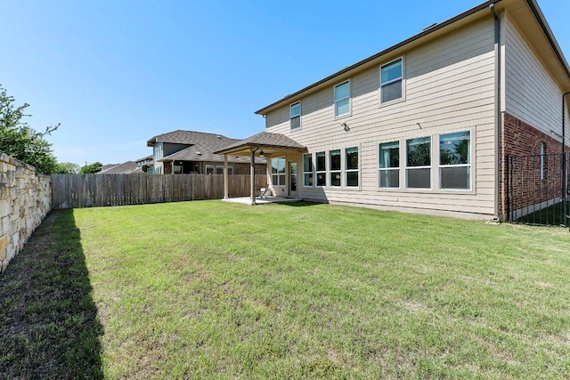 12207 Coronilla Bnd, Austin, TX 78748 - back of property featuring a patio area, brick siding, a fenced backyard, a ceiling fan, and a lawn