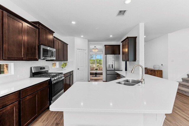 12207 Coronilla Bnd, Austin, TX 78748 - kitchen featuring light countertops, visible vents, appliances with stainless steel finishes, and a sink