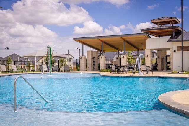 pool with fence, a residential view, and a patio