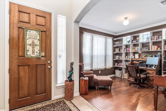 719 Walsh Hill Trl, Cedar Park, TX 78613 - entrance foyer featuring arched walkways, ornamental molding, baseboards, and wood finished floors