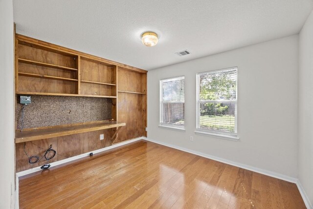 1444 Newbury St, Georgetown, TX 78626 - unfurnished office featuring baseboards and hardwood / wood-style flooring
