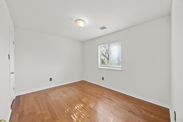 1444 Newbury St, Georgetown, TX 78626 - empty room featuring wood finished floors and baseboards