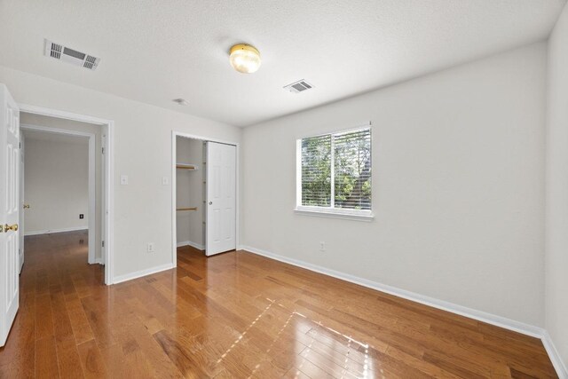 1444 Newbury St, Georgetown, TX 78626 - unfurnished bedroom with baseboards, wood finished floors, and a closet