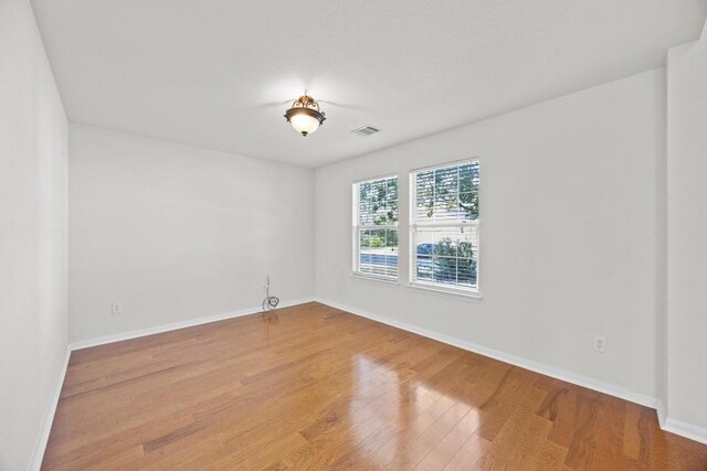 1444 Newbury St, Georgetown, TX 78626 - spare room featuring wood finished floors and baseboards
