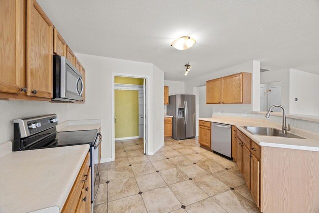 1444 Newbury St, Georgetown, TX 78626 - kitchen featuring stainless steel appliances, a sink, light countertops, a peninsula, and baseboards