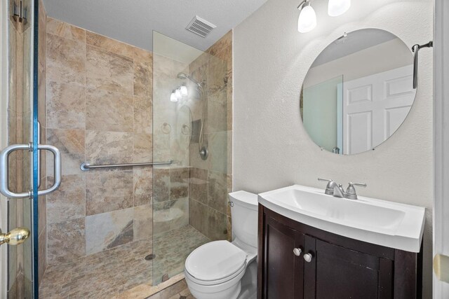1444 Newbury St, Georgetown, TX 78626 - full bathroom featuring vanity, a shower stall, and toilet
