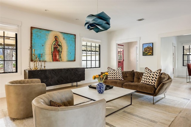 1004 Gaston Ave, Austin, TX 78703 - living room with plenty of natural light, wood finished floors, and baseboards