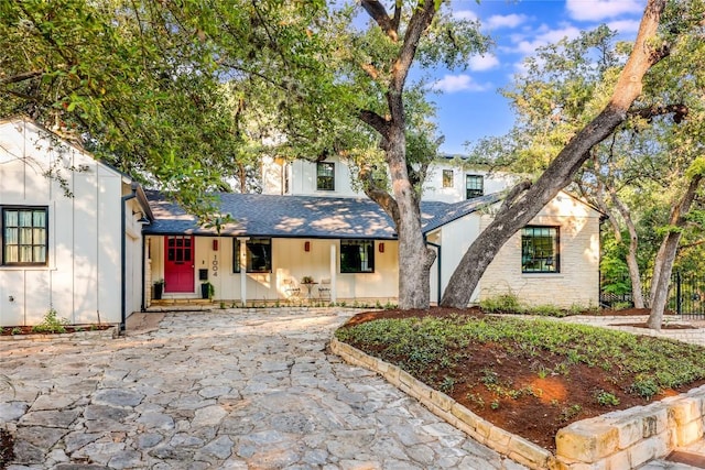 1004 Gaston Ave, Austin, TX 78703 - view of front of home with a porch, roof with shingles, and board and batten siding