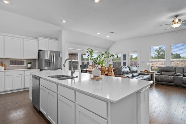 600 Spurlock Way, Liberty Hill, TX 78642 - kitchen featuring appliances with stainless steel finishes, vaulted ceiling, ceiling fan, open floor plan, and decorative backsplash