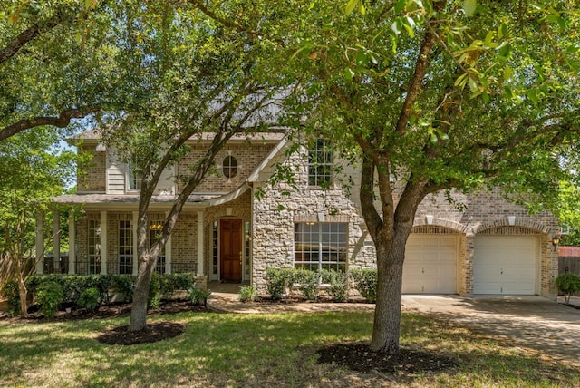 view of front of property with concrete driveway, an attached garage, brick siding, and a front lawn
