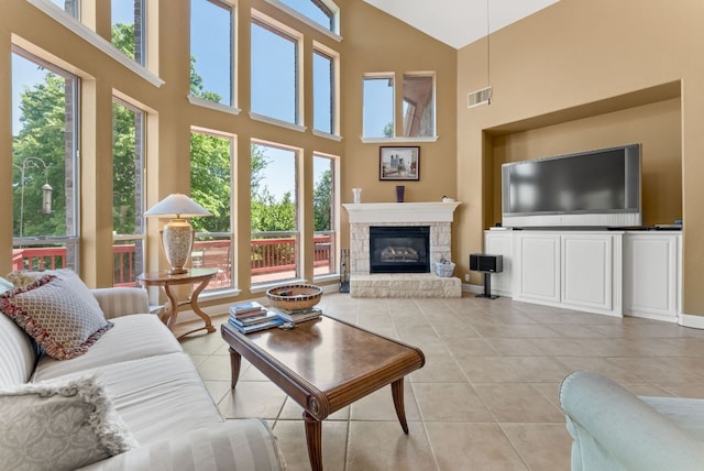 living area with visible vents, high vaulted ceiling, and a wealth of natural light